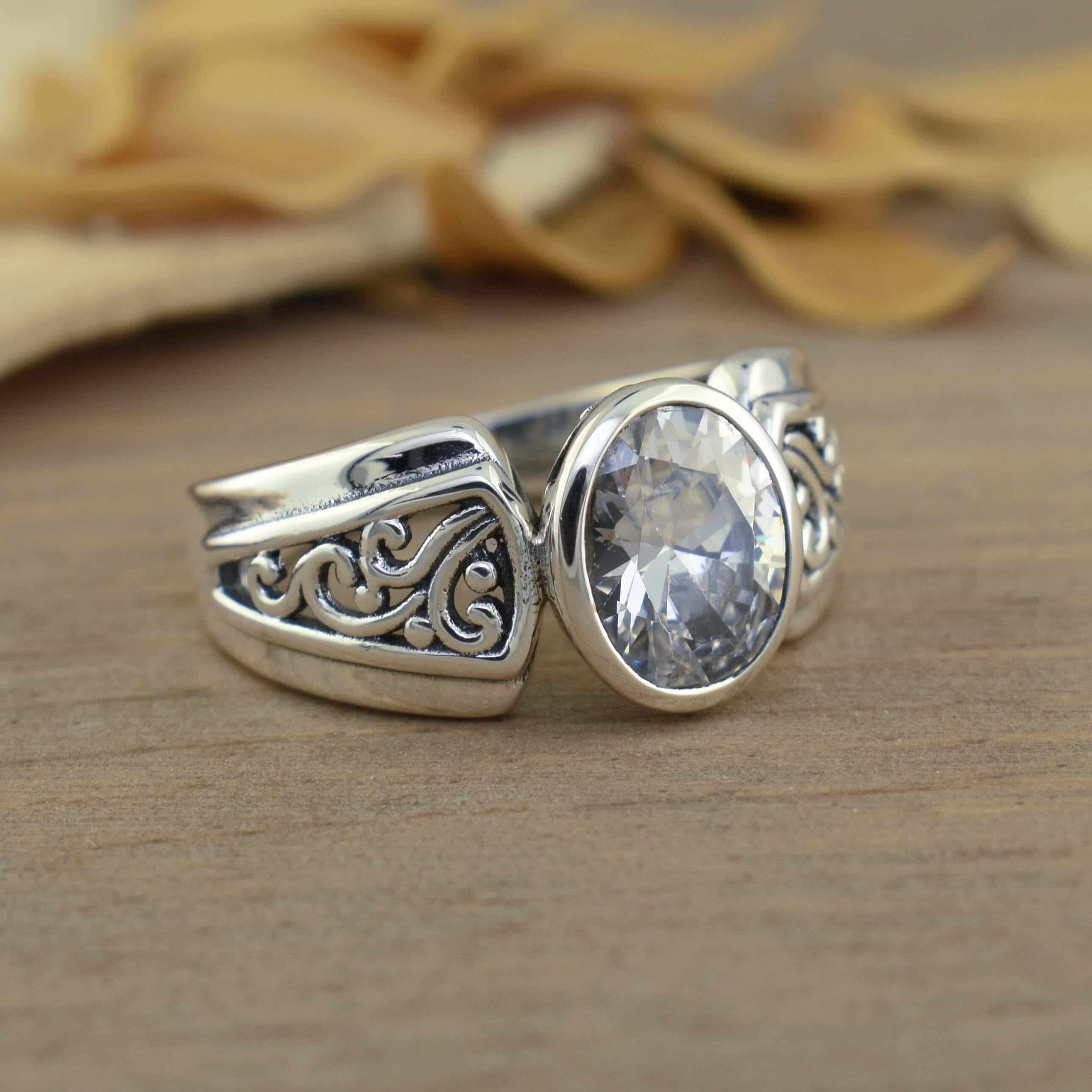 Ring with cutout filigree and oval stone in sterling silver