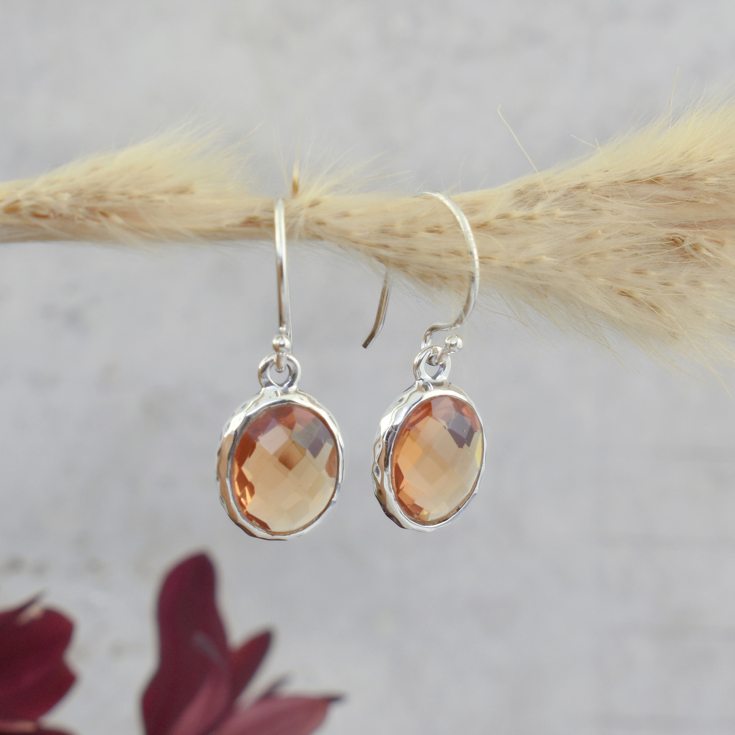 .925 sterling silver dangling earrings with an amber colored stone