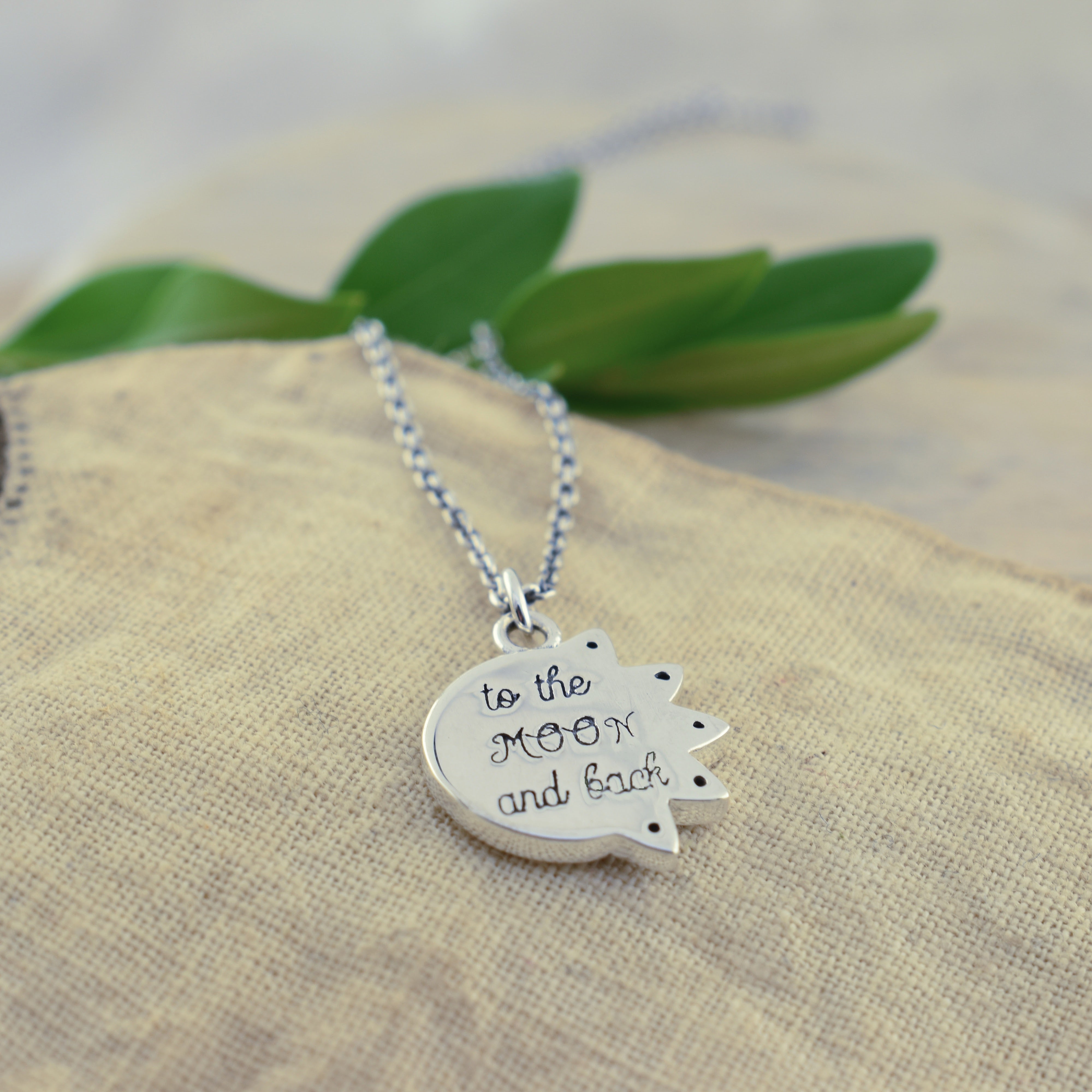 sun and moon necklace with "to the moon and back" inscribed on the back