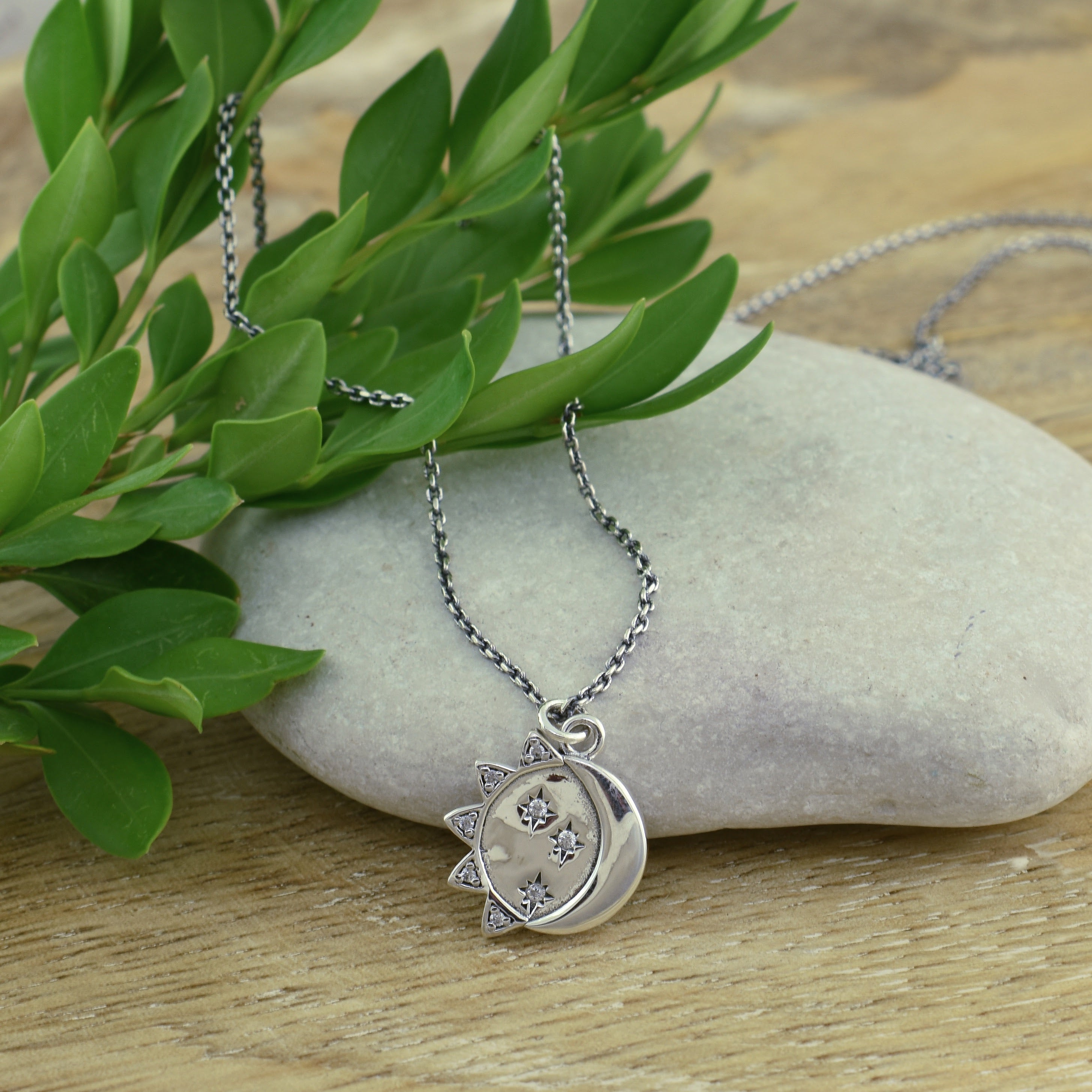 sterling silver sun and moon necklace featuring CZs